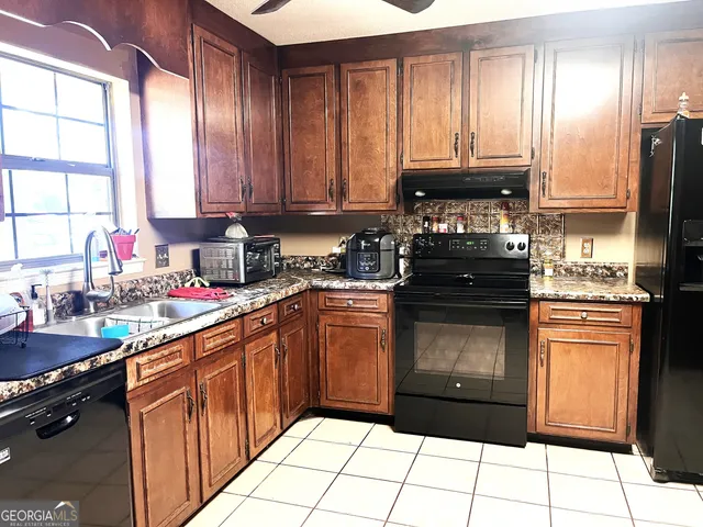 a kitchen with a sink stove and refrigerator