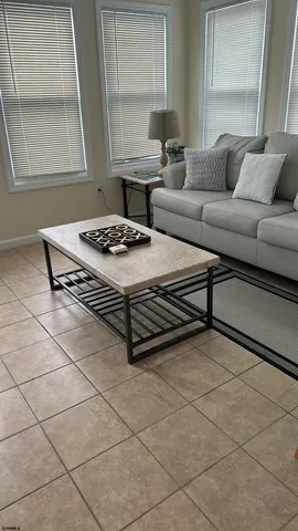 a living room with a couch coffee table and a window