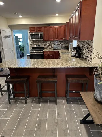 a kitchen with stainless steel appliances a stove a sink and a refrigerator