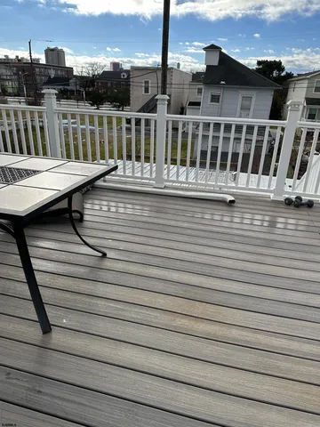 a view of a balcony with wooden floor