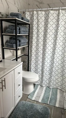 a bathroom with a toilet and a shower curtain