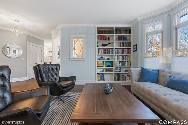 a living room with furniture and a book shelf