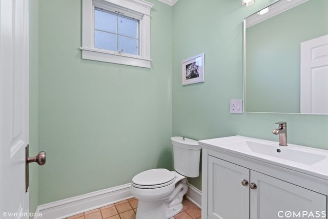 a bathroom with a sink mirror and toilet