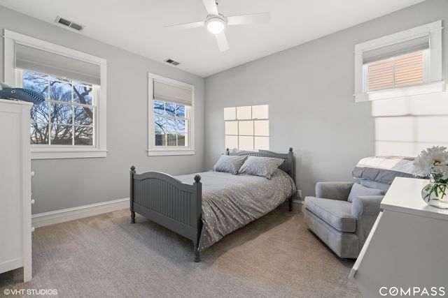 a living room with a bed furniture and a window
