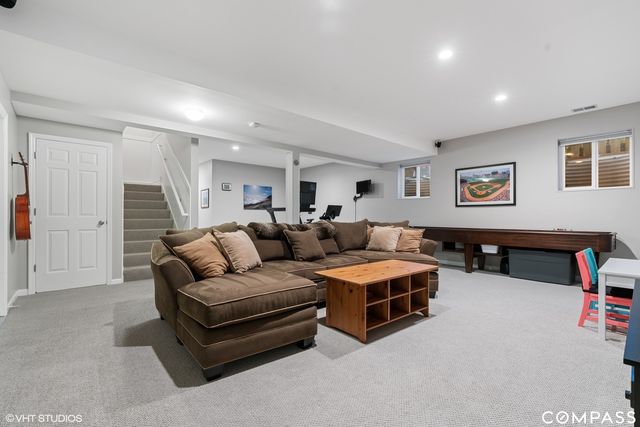 a living room with furniture and a ceiling fan