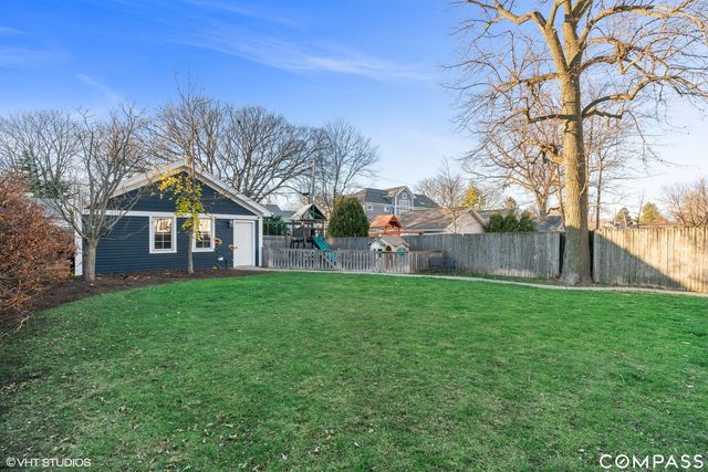 a view of a house with backyard and trees