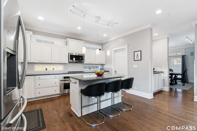 a kitchen with a sink cabinets and wooden floor