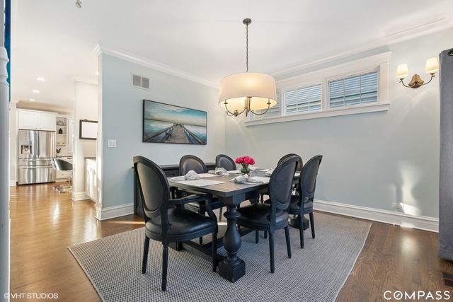 a view of a dining room with furniture wooden floor and chandelier