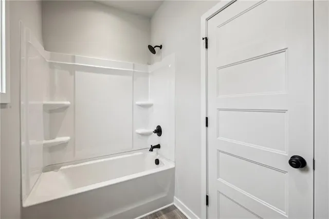 a car parked in front of a white house