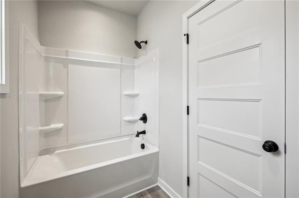 368 Scarlet Rose Way Hoschton, GA 30548 - Photo 38 of 150 a bathroom with a bathtub and a shower