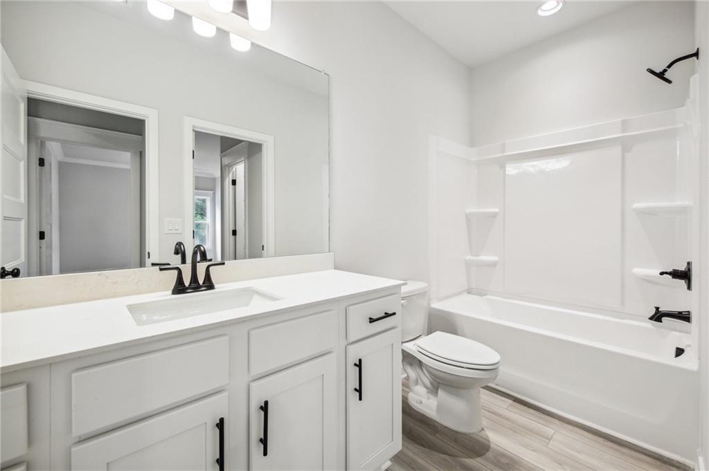 368 Scarlet Rose Way Hoschton, GA 30548 - Photo 39 of 150 a bathroom with a sink a toilet and a bathtub