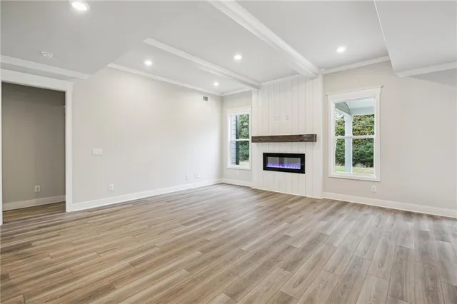 a view of a hallway with wooden floor and entryway