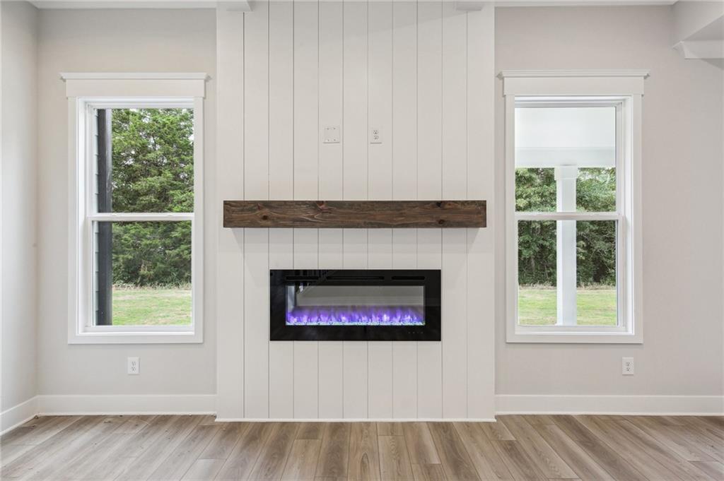 368 Scarlet Rose Way Hoschton, GA 30548 - Photo 8 of 150 a living room with a fireplace and a window