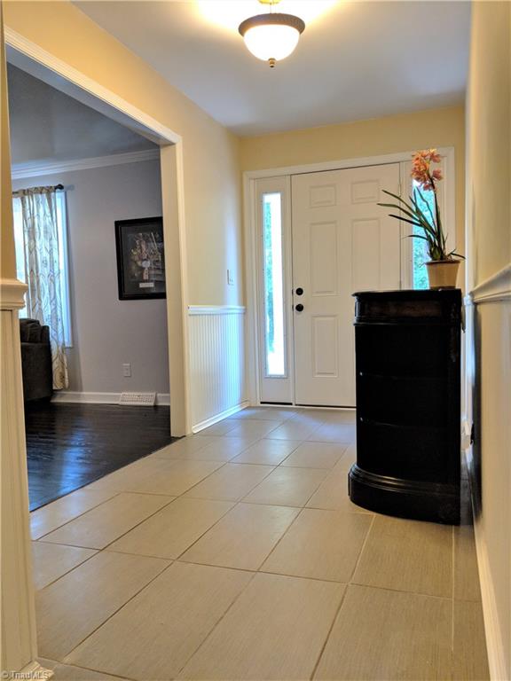 550 Pepperidge Road Lewisville, NC 27023 - Photo 2 of 30 Entry foyer (17 x 6) has new front door & frame, tile and wainscoting. Great double closet also for storage.