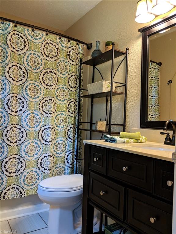 550 Pepperidge Road Lewisville, NC 27023 - Photo 18 of 30 Master Bath cute as a button, new flooring, fixtures and vanity with storage a plenty.