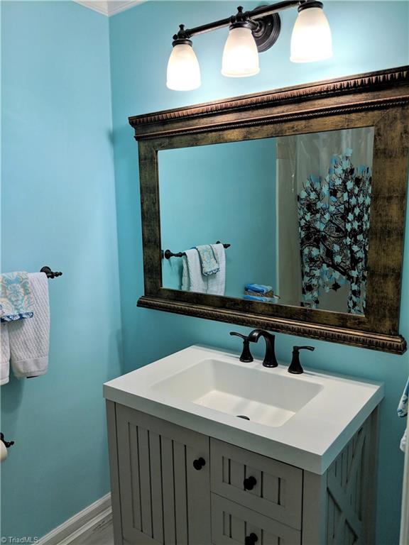 550 Pepperidge Road Lewisville, NC 27023 - Photo 22 of 30 Guest bath updated with new flooring, fixtures, and vanity.