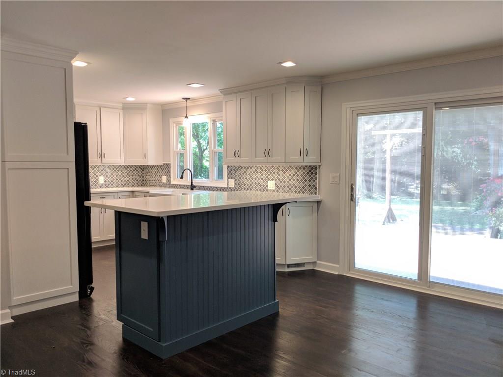 550 Pepperidge Road Lewisville, NC 27023 - Photo 9 of 30 Large kitchen island with plenty of room to entertain, also has USB ports. Sliding glass doors updated with built in shades (bonus) Let the sun shine in!