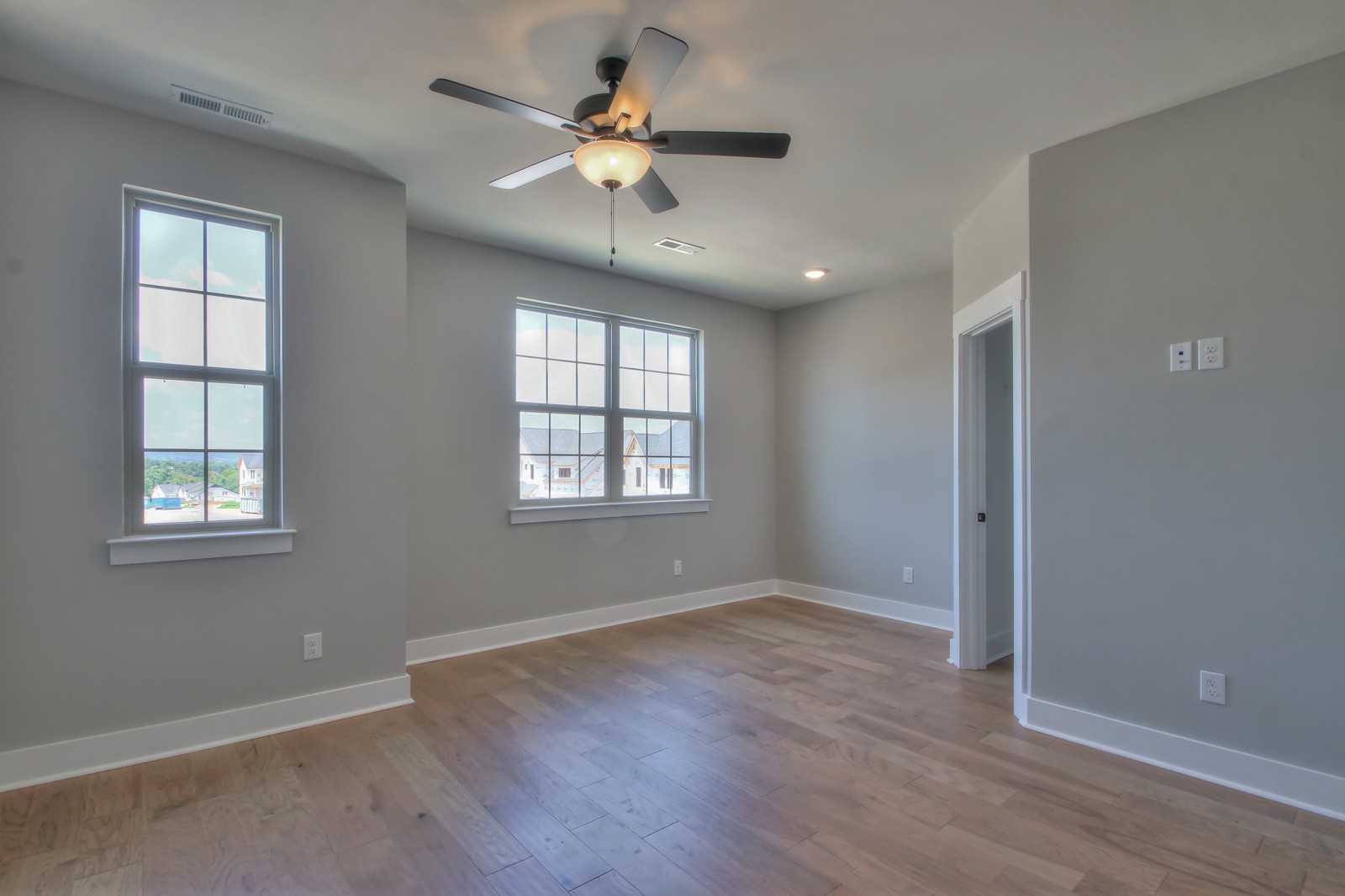 184 Phillips Bend Spring Hill Spring Hill, TN 37174 - Photo 22 of 39 an empty room with wooden floor chandelier fan and windows