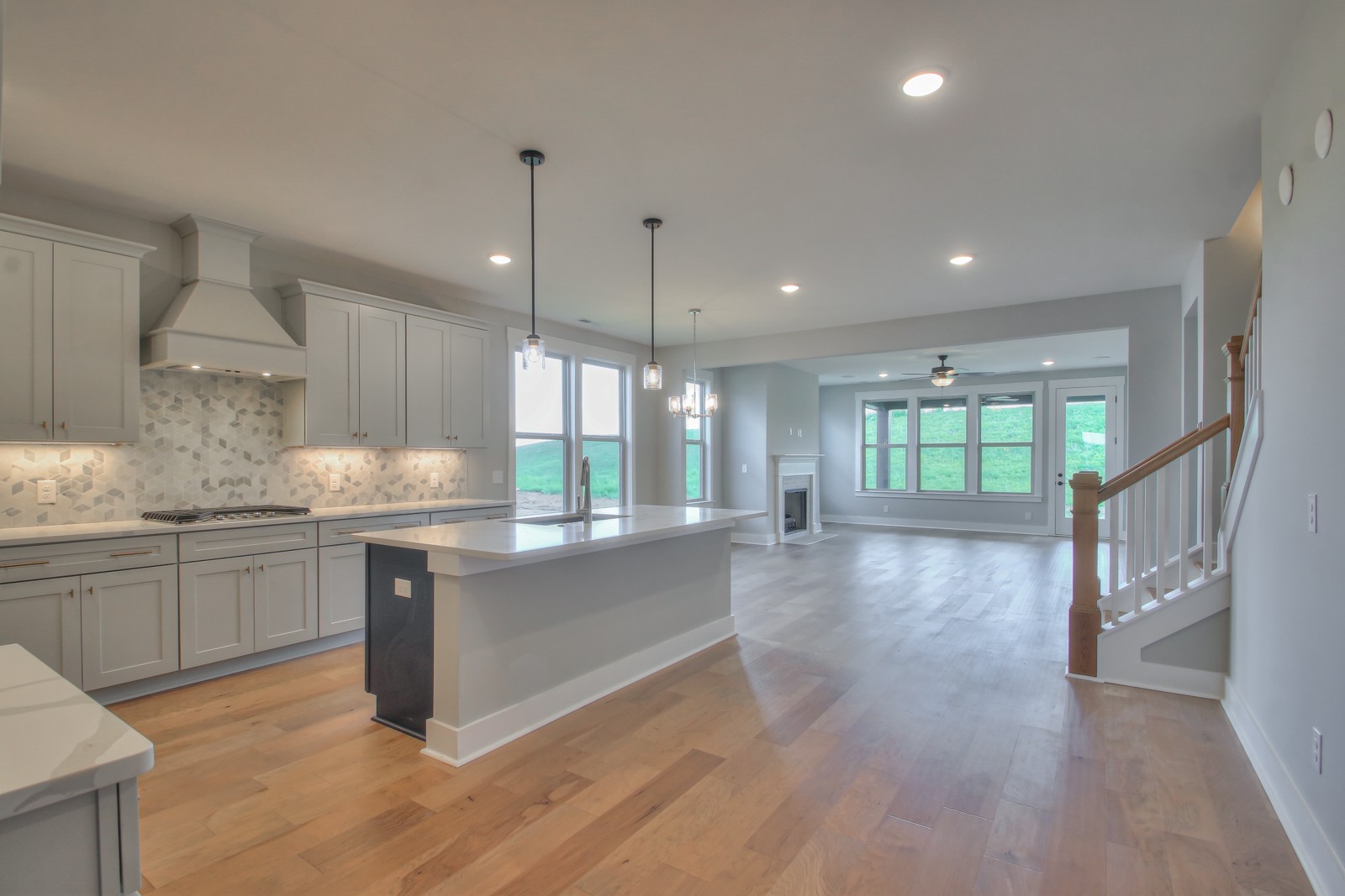 184 Phillips Bend Spring Hill Spring Hill, TN 37174 - Photo 8 of 39 a kitchen with granite countertop a stove a sink a center island and wooden floor