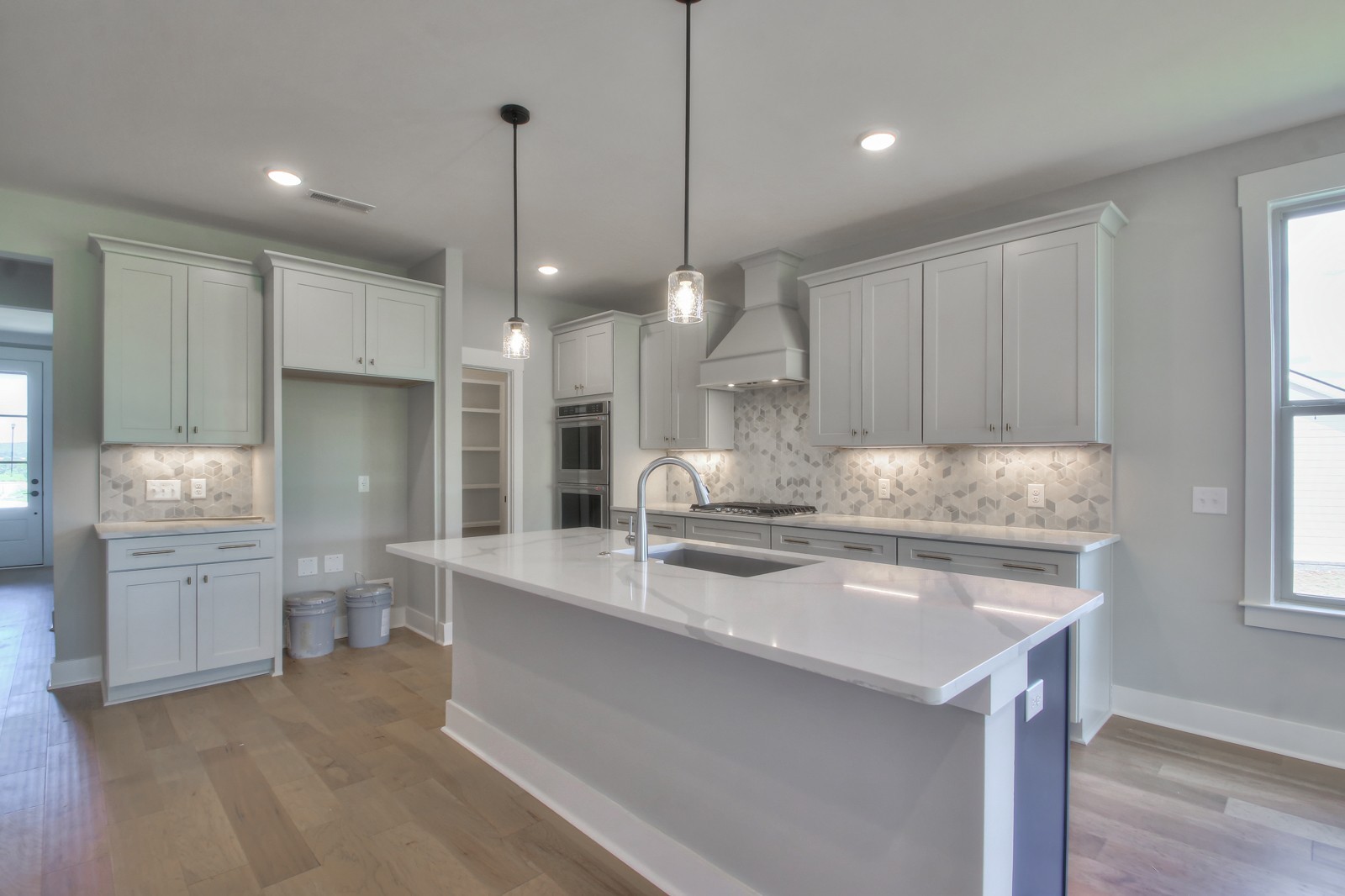184 Phillips Bend Spring Hill Spring Hill, TN 37174 - Photo 9 of 39 a kitchen with kitchen island granite countertop a sink cabinets and wooden floor