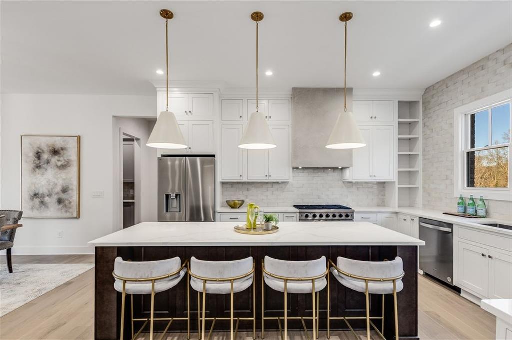 224 Pindos Place Southwest Powder Springs, GA 30127 - Photo 4 of 9 a kitchen with a dining table chairs and cabinets