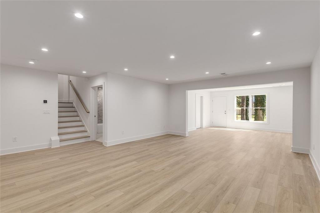224 Pindos Place Southwest Powder Springs, GA 30127 - Photo 6 of 9 a view of an empty room with wooden floor and stairs