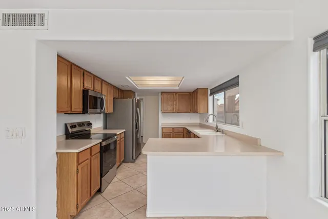 a kitchen with a sink cabinets and window