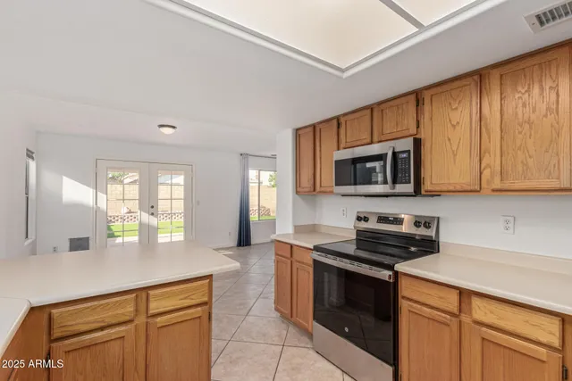 a kitchen with stainless steel appliances granite countertop a refrigerator and cabinets