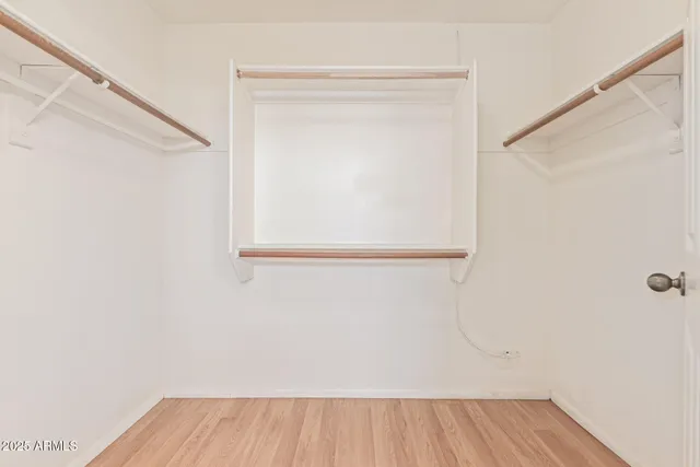 a view of a room with wooden floor and a window