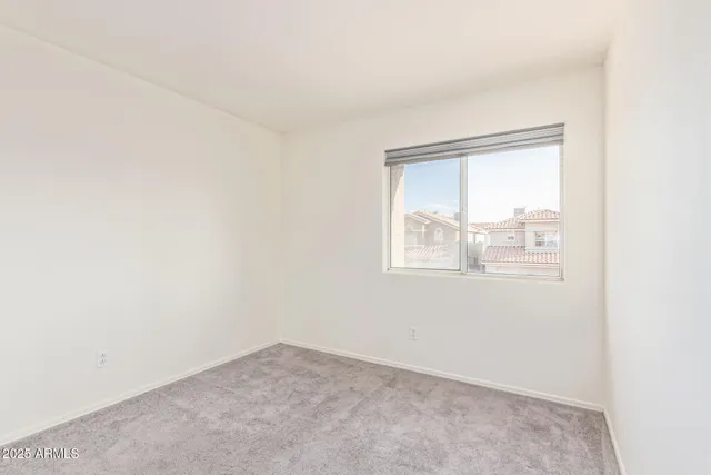 an empty room with mirror in closet