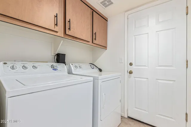 a view of empty room with refrigerator