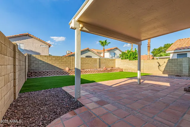 a view of a house with a yard and sitting area