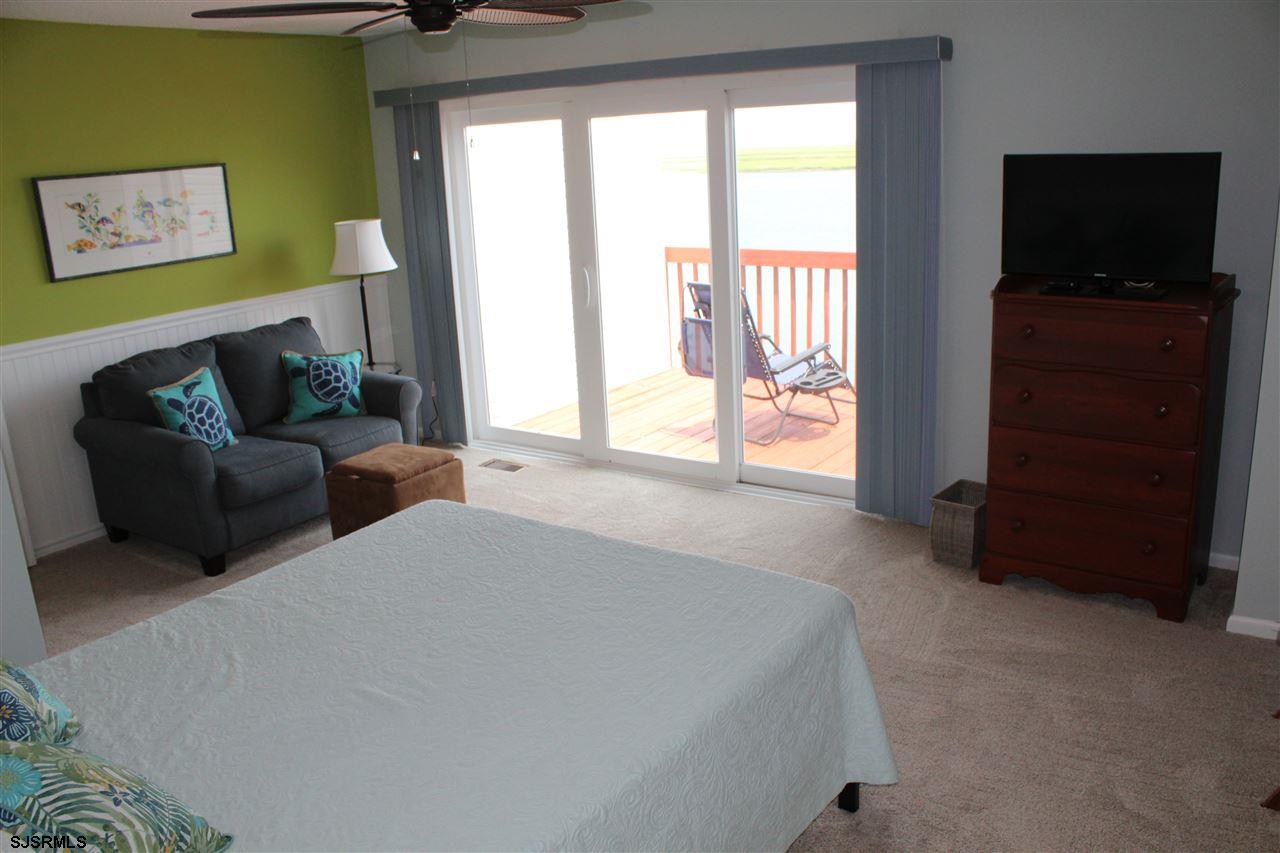 1101 East Shore Drive, Unit C Brigantine, NJ 08203 - Photo 11 of 22 a bed room with furniture and a flat screen tv