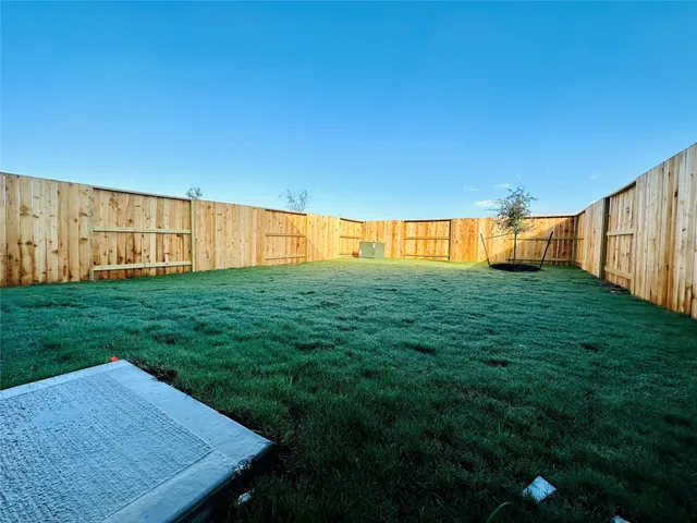 a view of an house with backyard space and garden