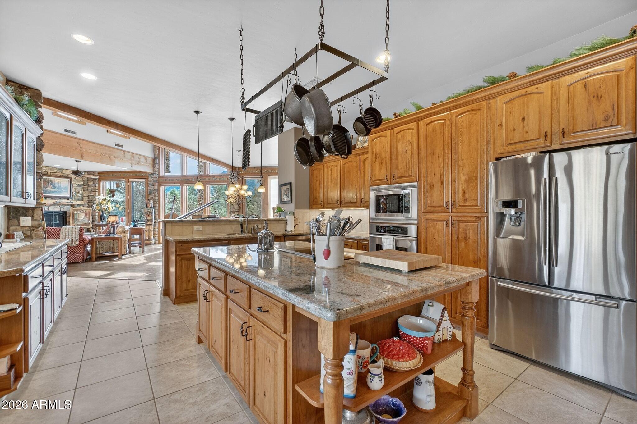 9820 Clear Fork Road Prescott, AZ 86305 - Photo 14 of 75 a kitchen with stainless steel appliances granite countertop a sink a stove and a refrigerator