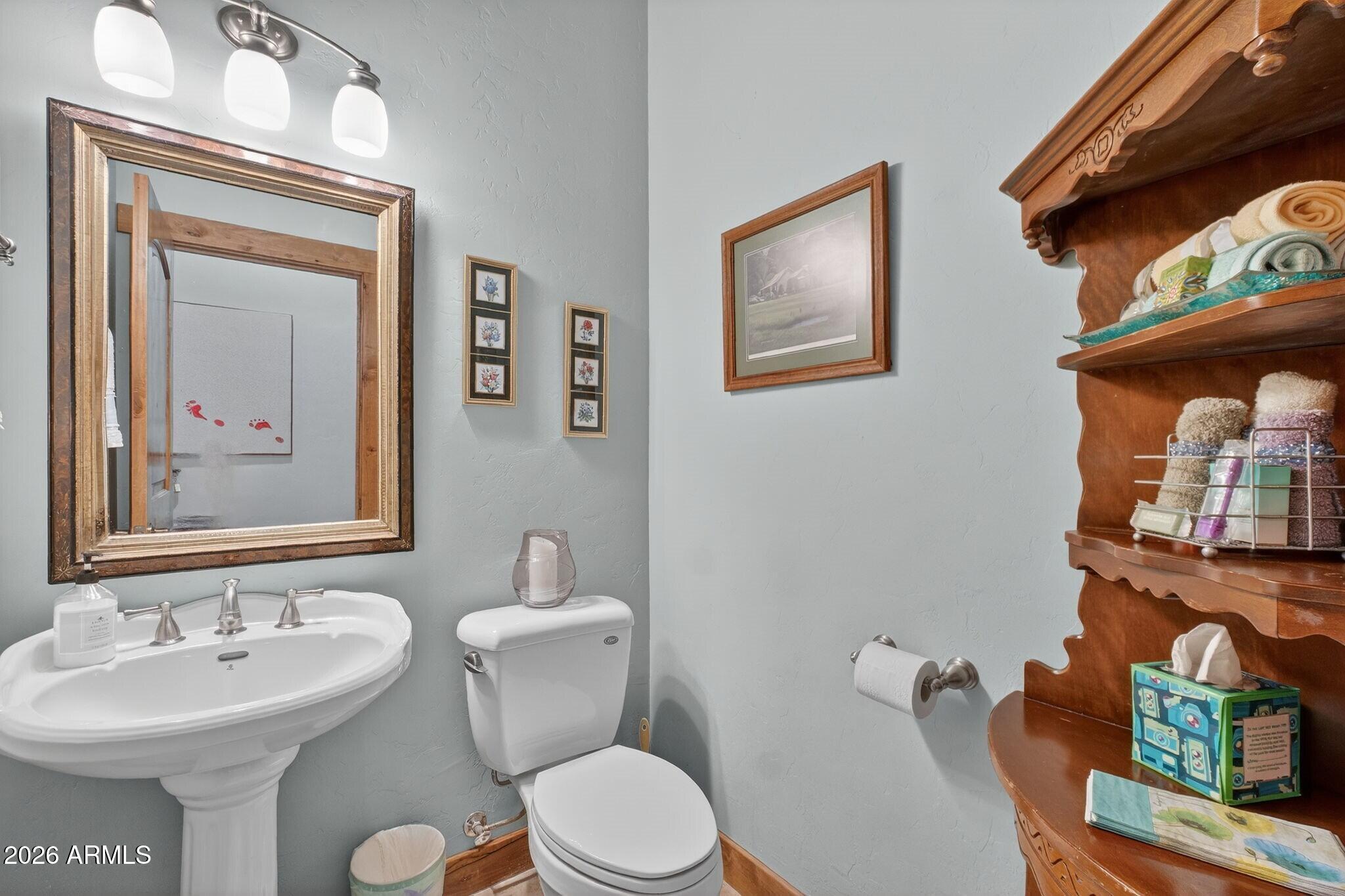 9820 Clear Fork Road Prescott, AZ 86305 - Photo 19 of 75 a bathroom with a toilet a sink and mirror