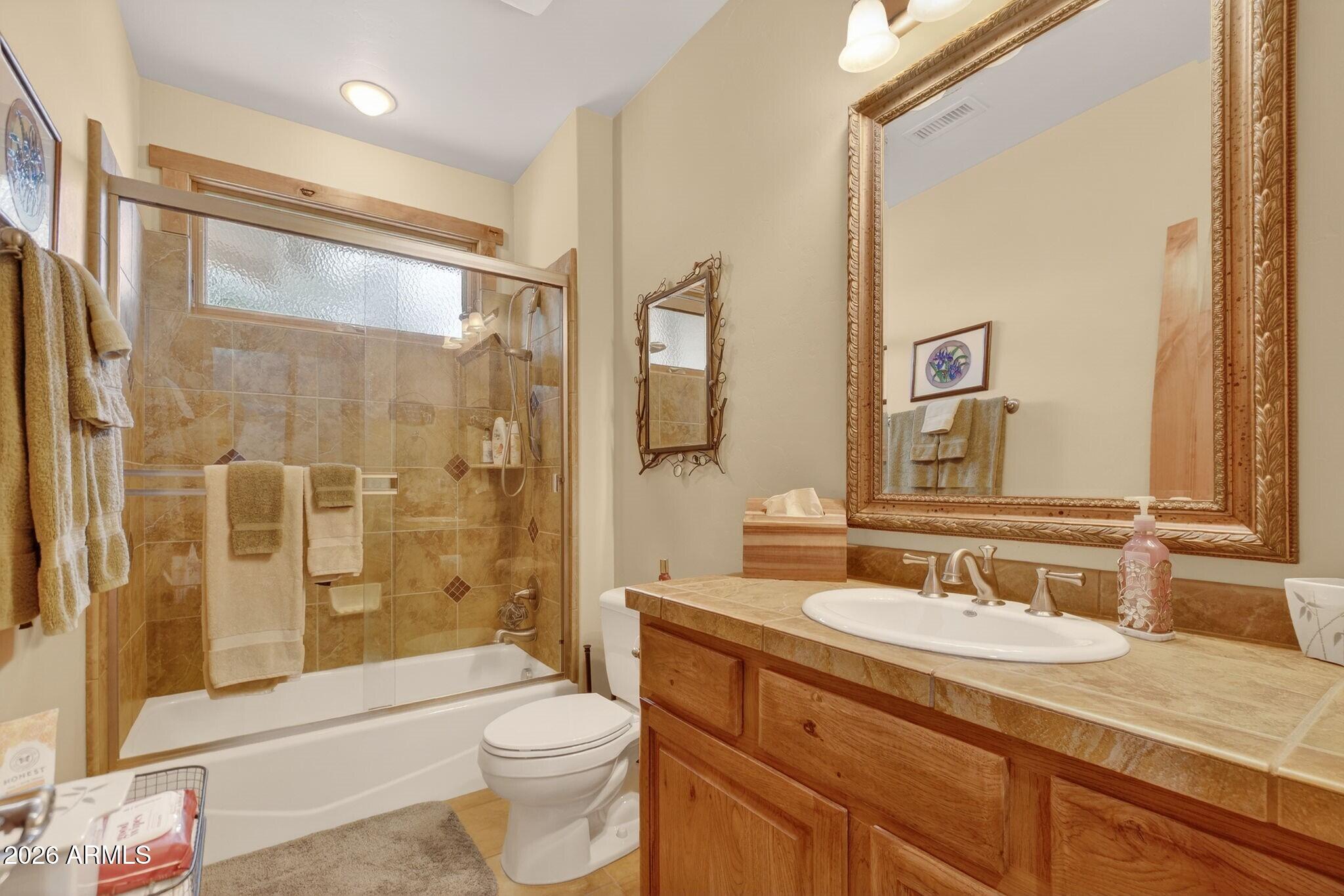 9820 Clear Fork Road Prescott, AZ 86305 - Photo 25 of 75 a bathroom with a granite countertop sink toilet and shower