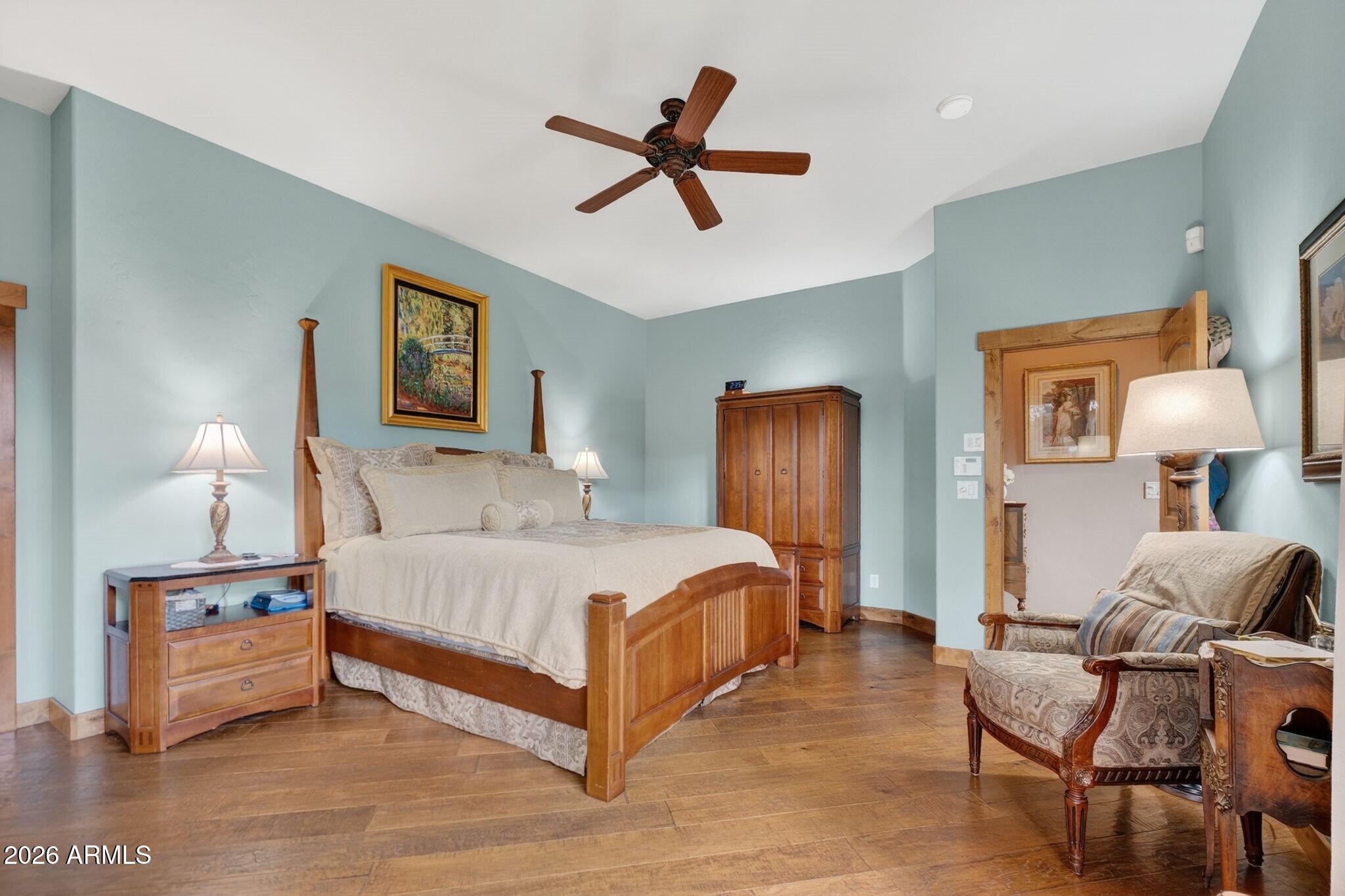 9820 Clear Fork Road Prescott, AZ 86305 - Photo 29 of 75 a spacious bedroom with a bed and painting on the wall