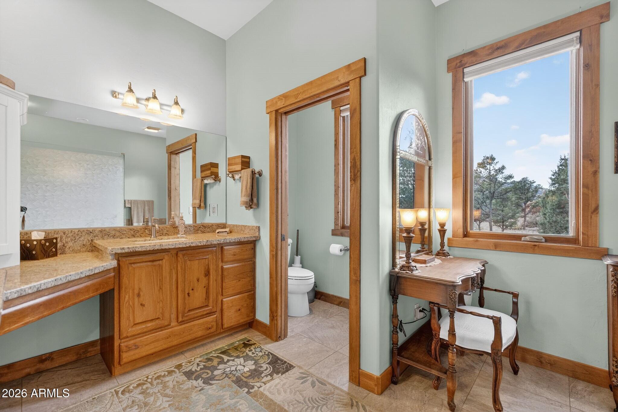 9820 Clear Fork Road Prescott, AZ 86305 - Photo 31 of 75 a spacious bathroom with a granite countertop sink and a mirror
