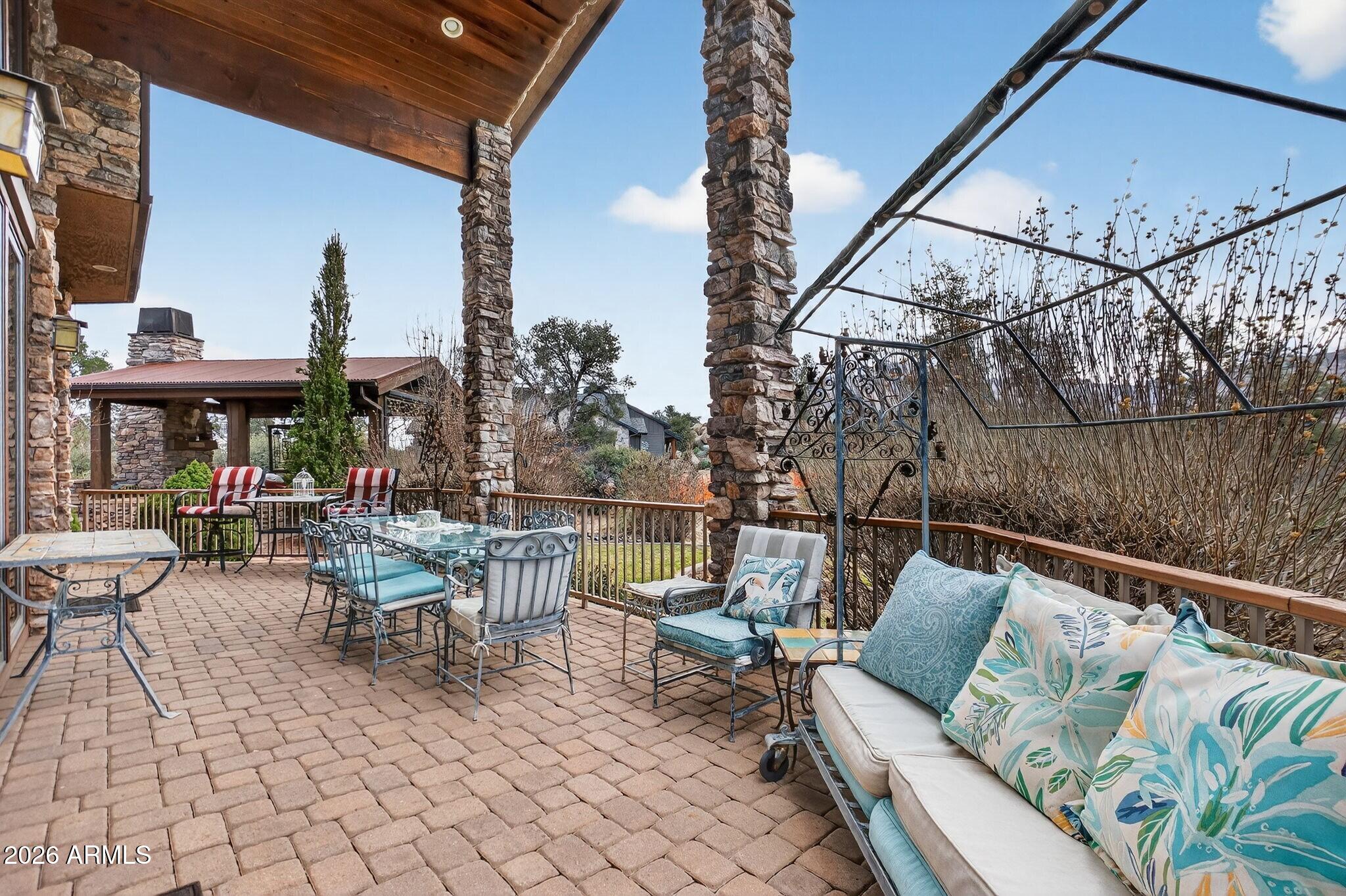 9820 Clear Fork Road Prescott, AZ 86305 - Photo 37 of 75 a view of a patio with couches table and chairs and potted plants