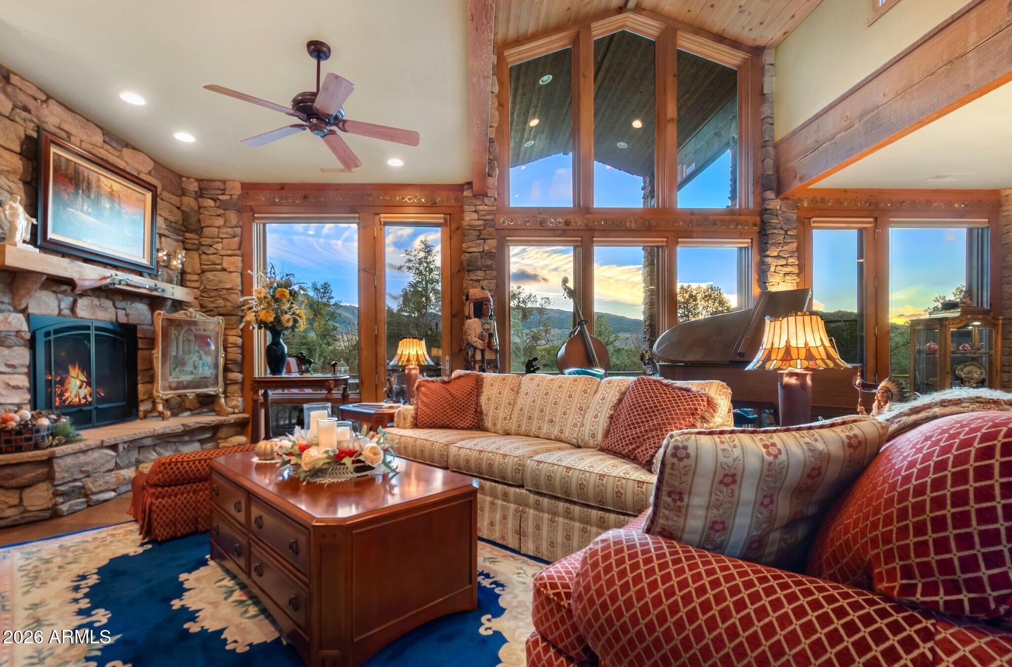9820 Clear Fork Road Prescott, AZ 86305 - Photo 4 of 75 a living room with furniture a ceiling fan and a fireplace