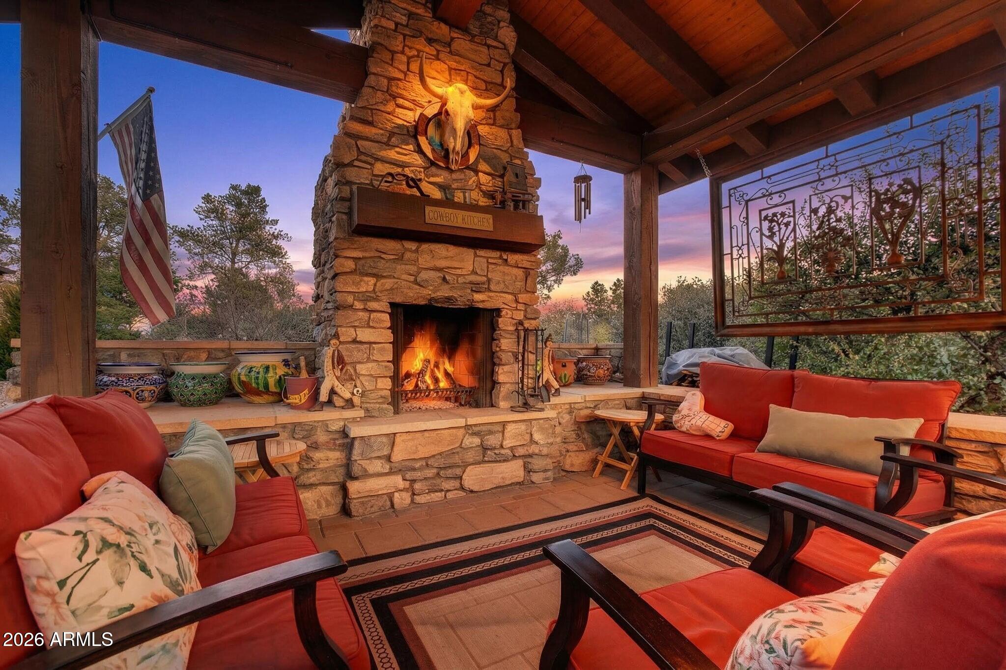 9820 Clear Fork Road Prescott, AZ 86305 - Photo 43 of 75 a living room with furniture a fireplace and a floor to ceiling window