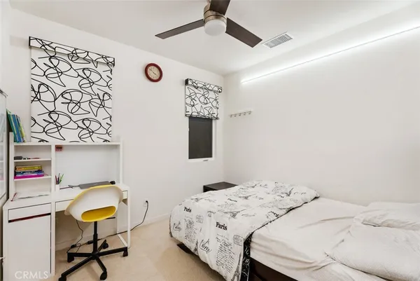 a bedroom with a bed and a chair in it