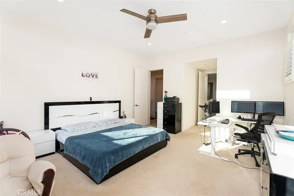 a bedroom with a bed a chair and table