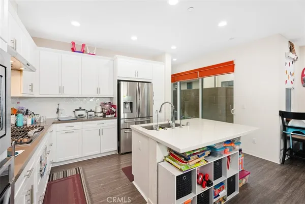 a kitchen that has a lot of cabinets a sink and a stove in it