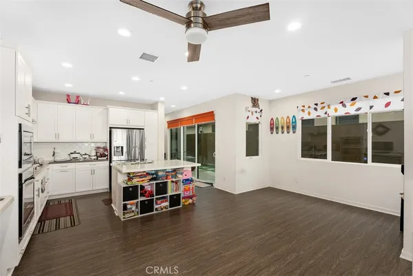 a view of a kitchen with furniture and wooden floor