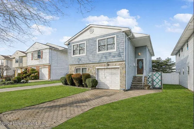 a front view of a house with a garden