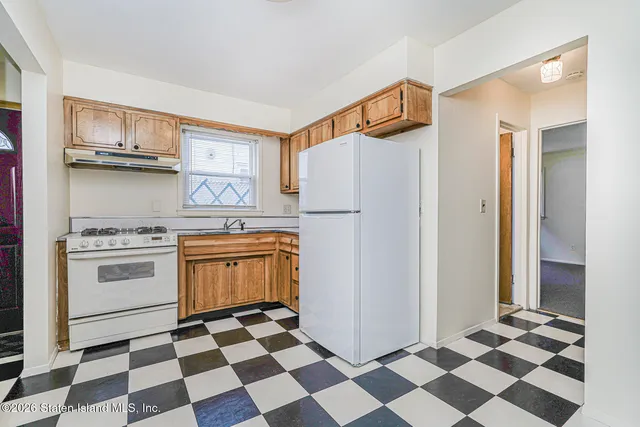 a kitchen with stainless steel appliances a stove a refrigerator and a cabinets