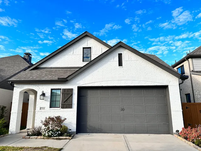 a front view of a house with a garage