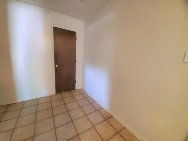a view of an empty room and wooden floor